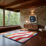 A modern abstract area rug with bold red, blue, yellow, and white geometric stripes lies on a dark wood floor in a mid-century modern living room with a stone wall, wooden ceiling, and large windows.