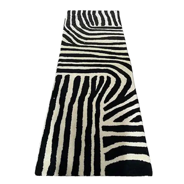 A stylish black and white runner rug featuring an abstract zebra stripe pattern, perfect for adding a contemporary touch to your kitchen, hallway, or bathroom. This hand-tufted wool rug blends modern design with timeless elegance, ideal as a kitchen runner rug or hallway runner rug.