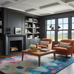 A styled living room interior featuring two rust-orange armchairs with striped pillows, a wooden coffee table, a large abstract blue, pink, and cream area rug, dark charcoal built-in cabinetry and fireplace, and tall windows overlooking a green landscape.