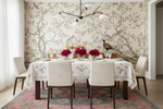 Dining room with floral rug, table, chairs, and decorative elements.