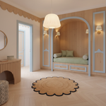 A beautifully styled children's bedroom featuring light wood paneling, a built-in daybed with green striped bedding, a scalloped jute rug, and a modern cream pendant light.