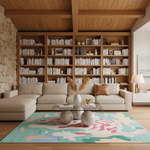 A modern living room featuring a large beige sectional sofa in front of a massive wooden bookcase, with a colorful abstract area rug on a light wood floor.