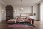 A modern living room featuring a dusty pink modular sectional sofa with matching pillows, styled with a pink and black patterned rug, a glass coffee table, and a sleek kitchen backdrop in the background.