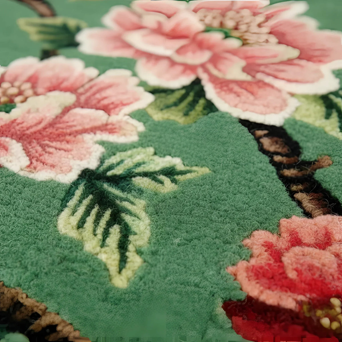 Close-up of a floral patterned rug with pink flowers and green leaves.