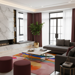 A modern living room interior with a gray sectional sofa, marble coffee table, colorful abstract rug, burgundy curtains, a fireplace, and a potted plant.