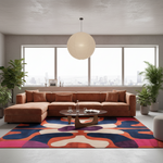 A modern living room featuring a large rust-brown sectional sofa, a colorful abstract-patterned area rug, a round coffee table, and a large spherical pendant light hanging over the couch. The room is styled with potted plants and has a large window looking out onto a city skyline.