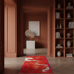 A long red runner rug with a leopard print pattern is displayed on a herringbone wood floor in a warm, modern interior with terracotta walls and built-in bookshelves.